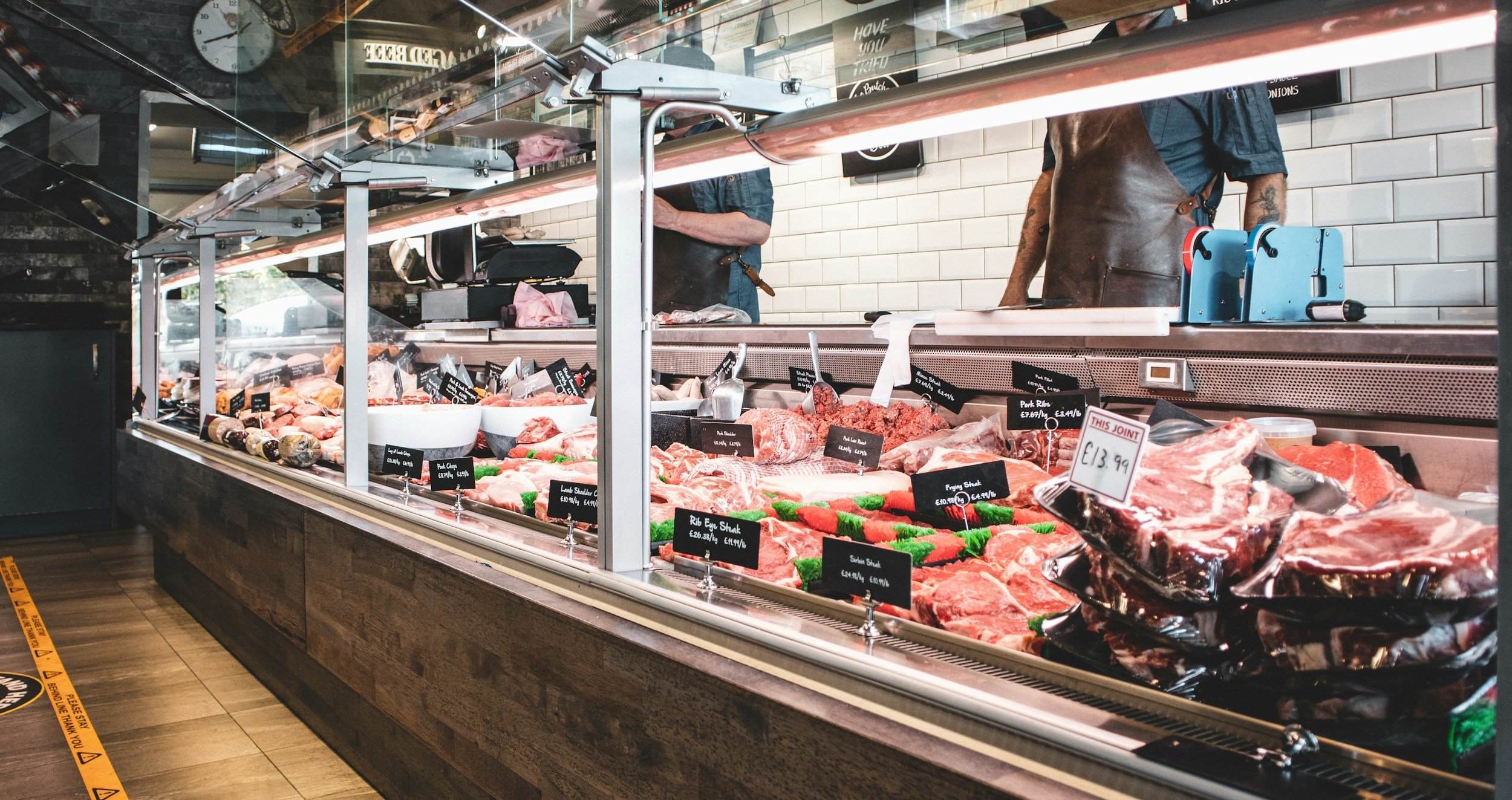 A full fresh meat counter at a grocery store